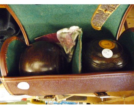 CASED BOWLS. Leather cased set of vintage bowls
