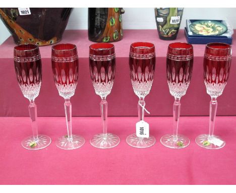 Six Waterford Crystal 'Clarendon' Ruby Flutes, raised on star cut bases, etched marks and labels, 25cm high.Lot 1016 - no vis