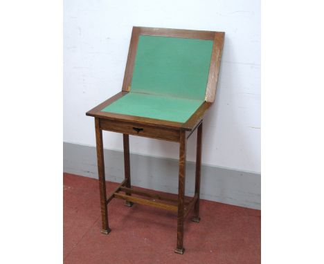 An Arts &amp; Crafts Oak Card Table, with swivel top and baized interior, on square supports, united by stretchers, stamped "