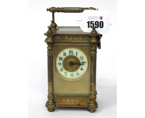 A French Brass Cased Late XIX Century Carriage Clock, with rounded side pillars and moulded flowerhead and diamond bands, the