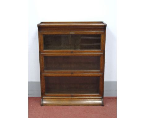 An Early XX Century Oak Globe Wernicke Style Three Height Sectional Bookcase, with presentation plaque "John Henry Chapman on