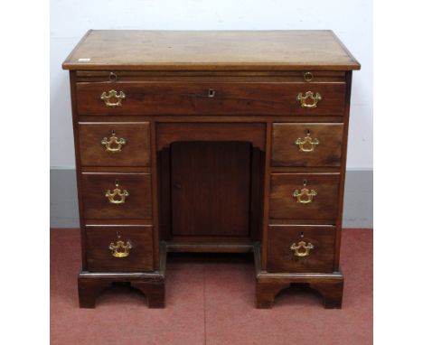 A Mid XVIII Century Mahogany Kneehole Desk, with brushing slide over a single long drawer, the pedestals with drawers and cup