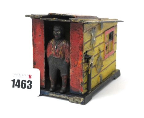 A Late XIX Century Mechanical Cast Iron Money Box Cast as an African Gentleman Standing in the Doorway of a Yellow Panelled S