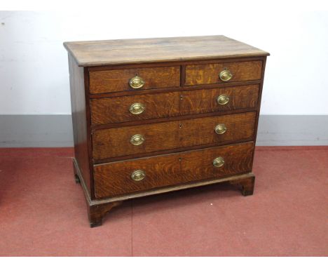 An Early XIX Century Oak Chest of Drawers, the top with a moulded edge over two short and three long drawers, on bracket feet