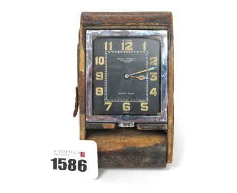 A Le Coultre 'Birch and Gaydon Ltd' Travelling Clock, the black dial with Arabic numerals, in a leather case, 10.5cm long.