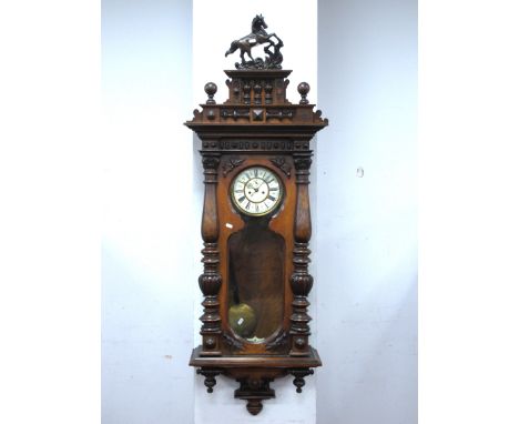 A XIX Century Walnut Two Weight Vienna Wall Clock, with applied pediment with a figure of a horse, stepped cornice and shaped