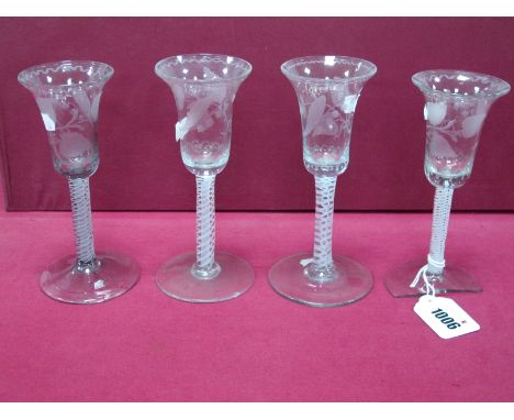 A Set of Four XIX Century Wine Glasses, the bell shaped bowls etched with lily of the valley and raised on white enamel twist