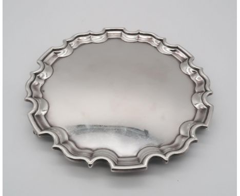 An Elizabeth II silver salver, of shaped form, with a chippendale style piecrust edge, by Laings Ltd, Edinburgh 1996, on thre