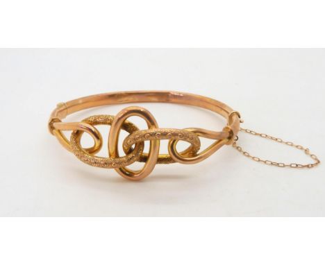 A vintage knot bangle, stamped 18c,&nbsp; weight 9.7gms Condition Report:A bit battered &amp; bent, clasp works fine.