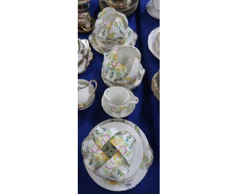 A Royal Doulton teaset decorated with flowers and leaves, the cups of fluted form, pattern number H4143, comprising two cake 