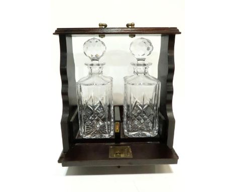 A two decanter tantalus&nbsp; Condition Report:Available upon request