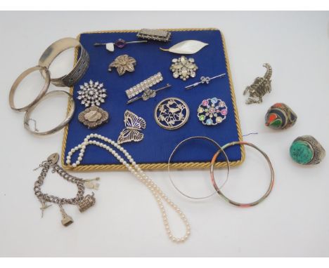 A silver and white enamel leaf brooch by David Andersen, A RAF sweetheart brooch, silver brooches, bangles and other items Co