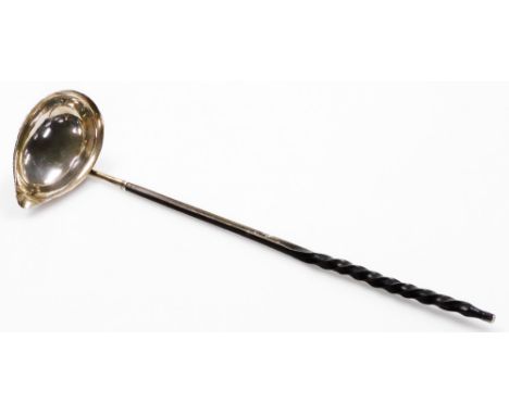 An early 19thC toddy ladle, with whale bone handle and plain oval bowl, unmarked white metal, 32cm long.