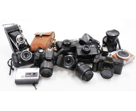 A group of cameras and camera equipment, to include a Cannon EOS, a Dixons disk 2500, Nikon 18-15mm lens, Toshiba 201S flash,