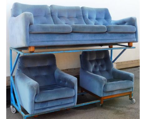 A 1970s/80s retro blue draylon sofa suite, comprising three seater sofa and two armchairs, teak turned legs, the sofa 70cm hi