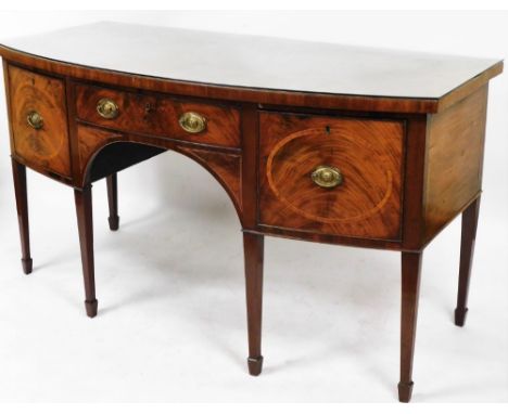 A George III mahogany bow fronted sideboard, with cross banded top raised above a frieze drawer flanked by deep drawer and ce