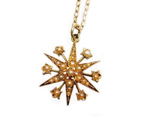 An Edwardian pendant and chain, the star pendant set with various seed pearls, in a yellow metal backing, marked 15ct, 2cm wi