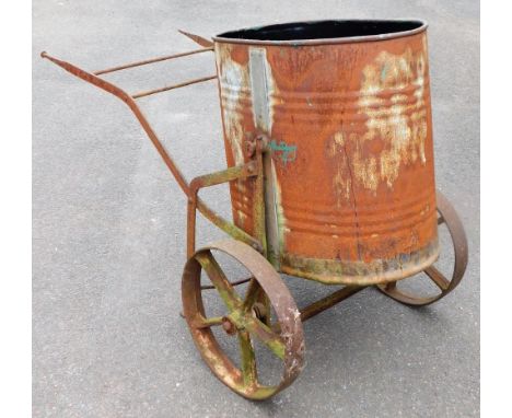 A vintage galvanised water butt, on a wheel barrow type metal frame, 87cm high, 132cm wide.