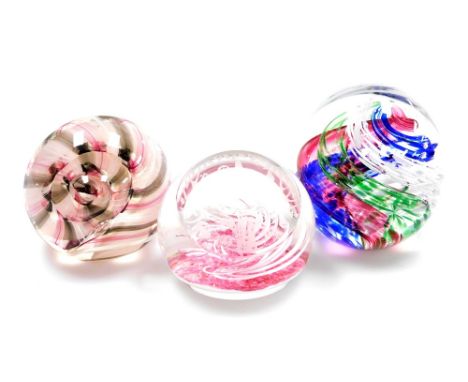 Three glass paperweights, to include a Caithness ribbons pattern paperweight, a Selkirk glass paperweight, dated 1979 and a f