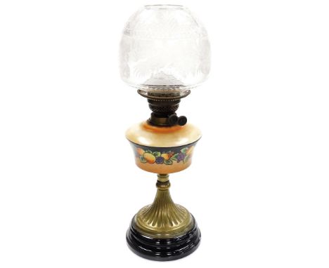 A Lambeth Works late 19thC oil lamp, the peach coloured glass reservoir decorated with flowers, on a tapered brass stem base,