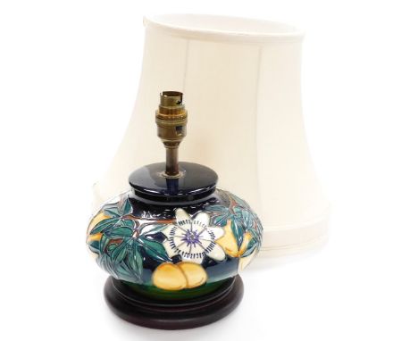 A Moorcroft squat table lamp, decorated with flowers and fruits, numbered to underside 249i, on a stepped base, with shade, 2