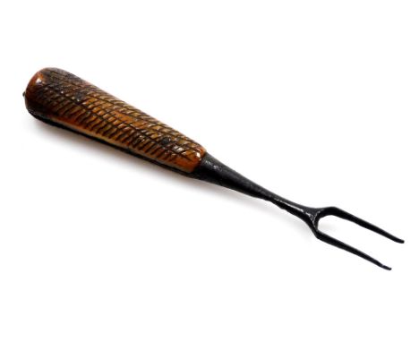 A Prisoner of War toasting fork, with a carved bone handle, on metal two prong, 15cm long.