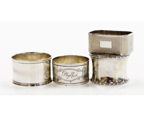 Four silver napkin rings, comprising an Edwardian silver napkin ring, engine turned, Birmingham 1905, and three further napki