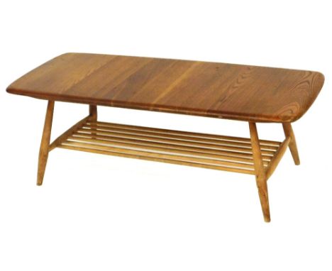 A light elm Ercol style rectangular coffee table, with magazine rack below, 35cm high, 107cm wide, 46cm deep.