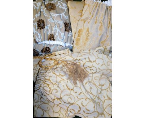 Four pairs of curtains, to include two pairs of gold floral curtains, each curtain 140cm high, 110cm wide, and a gold tie bac