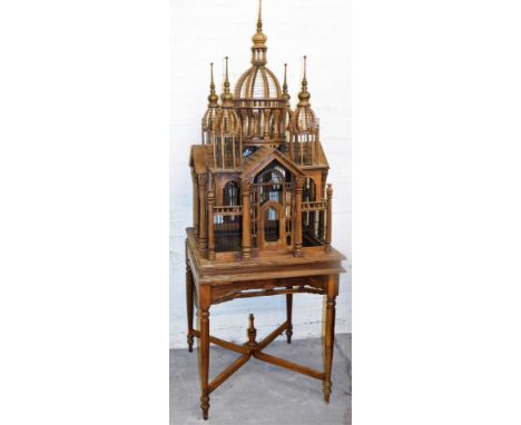A bird cage model of the Taj Mahal, on a wooden base, the model figure 110cm high, with additional table height  totalling 19