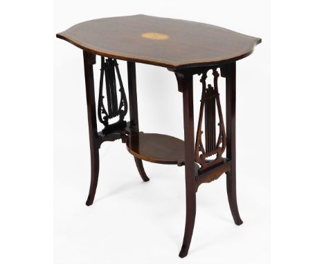 An Edwardian side table, the flared shaped top with parquetry shell inlay on lyre end supports with lower tier shelf on splay