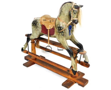 A vintage Victorian style child's rocking horse, with pine frame and sectional horse with realistic mane, leather tackle and 