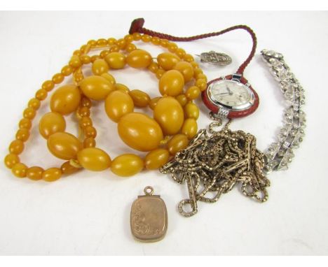 A string of amber style beads, 67.1g, Herma nurse's watch, long guard muff chain and further costume jewellery.