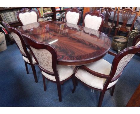 A Italian style dining table, the veneered top with a broad border painted simulate wood, on a centre column, four splayed le