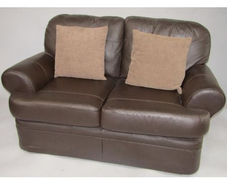 A leather two seater sofa, with two loose cushions.