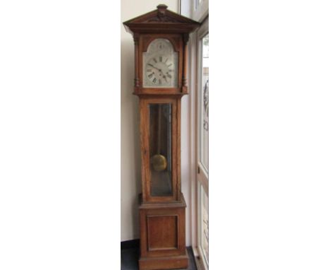 A late 19thC oak longcase clock by Thomas Armstrong & Brother, Manchester, the engraved silvered break arch dial with chapter