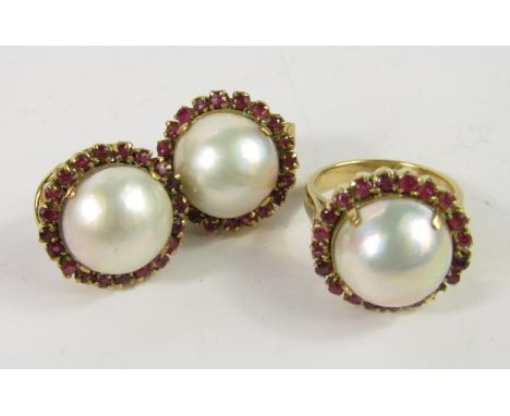 A yellow metal Mabe pearl and ruby ring, size L, one ruby lacking and a pair of matching earrings, believed to be 18ct, 17.5g
