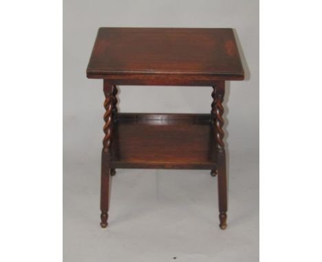 A 1920's oak card table, the rectangular hinged top with a baize interior on spirally turned supports with galleried under ti