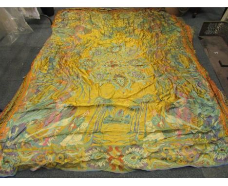 An early 20thC machine embroidery bedspread, with Middle Eastern figures and an oasis with tasselled border, a machine tapest