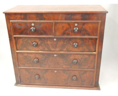 A Victorian mahogany chest of drawers, the rectangular top above two short and three long drawers, each with turned wood hand