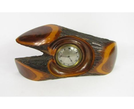 A Regal Mulga Wood mantel clock, movement by Armstrong, Manchester, silvered dial bearing Roman numerals, 43cm long.