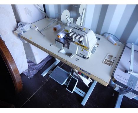 A Wimsew 747 electric sewing machine, treadle table attachments and accessories.