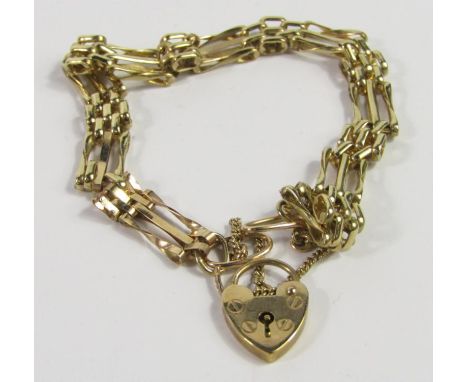 A 9ct gold triple bar gate bracelet, on a heart shaped padlock clasp, with safety chain as fitted,15.4g.