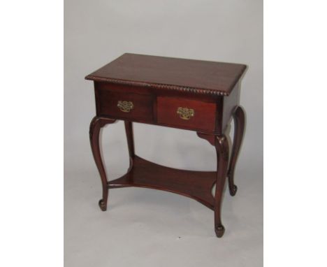 A hardwood side table, the rectangular top with a carved border, above two frieze drawers on cabriole legs with shaped under 