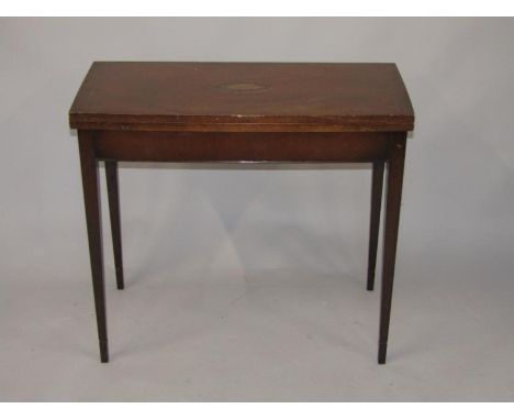 An early 20thC mahogany card table, the bow fronted top inlaid centrally with a shell on square tapering legs, 82cm wide.