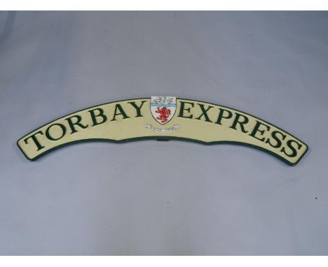 A cast metal and enamel replica train headboard Torbay Express, with coat of arms and crest, 135cm long.