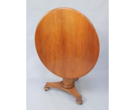 A Victorian mahogany breakfast table, the circular top with a moulded edge, on a tapering octagonal column and a concave trif