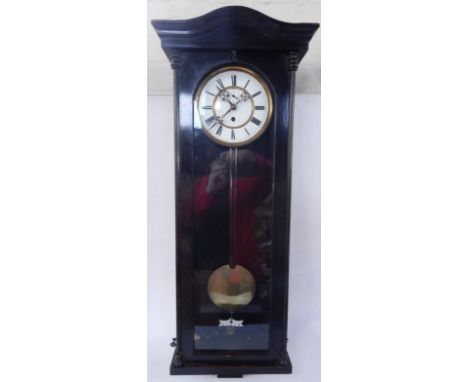 A late 19thC ebonised wall clock, circular brass and enamel dial and chapter ring bearing Roman numerals, subsidiary seconds 