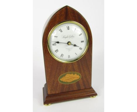 A Knight & Gibbins mahogany cased mantel clock, circular dial bearing Roman numerals, battery operated Quartz movement, domed