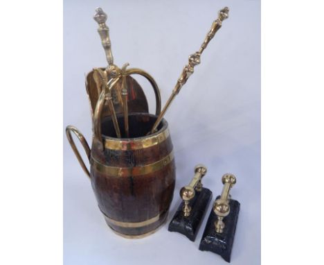 An oak and brass bound barrel coal scuttle, brass shovel, pair of brass and cast iron andirons, and three brass fire tools.